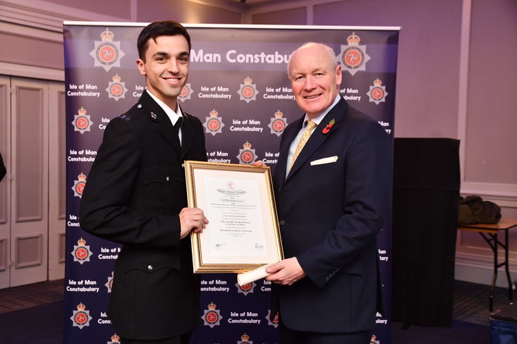 Constable Timothy Downward (left) receives the Chief Constables Commendation & Royal Hume Society resuscitation certificate from Lieutenant Governor Sir John Loirmer after helping save a man's life following a medical episode in Peel