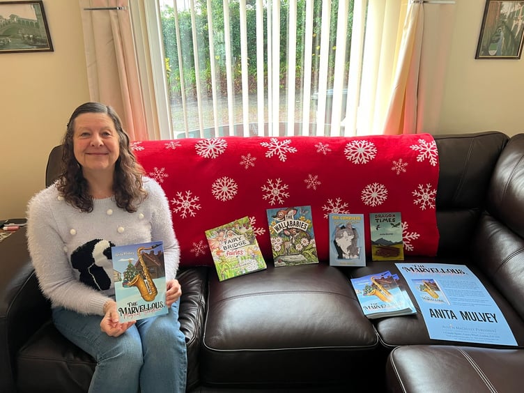 Anita Mulvey with all of her published books to date, including her new book 'The Marvellous Magical Saxophone'