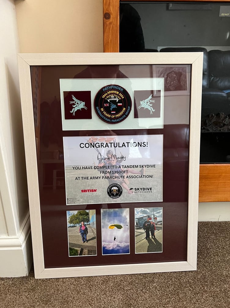 A special frame which commemorates Anita's sky-diving fundraising
