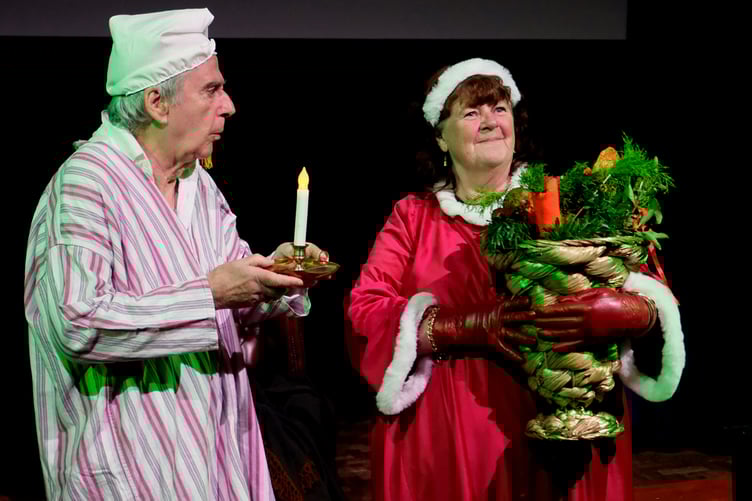 Jack Verity as Scrooge and Danny Berry as the Ghost of Christmas Present