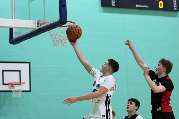Logan Glover hits a fast break lay-up for Jets as Matt Jones chases down for Ravens (Photo: Darwin Gilmore)