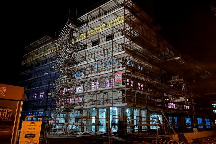 The development is lit up pink and blue