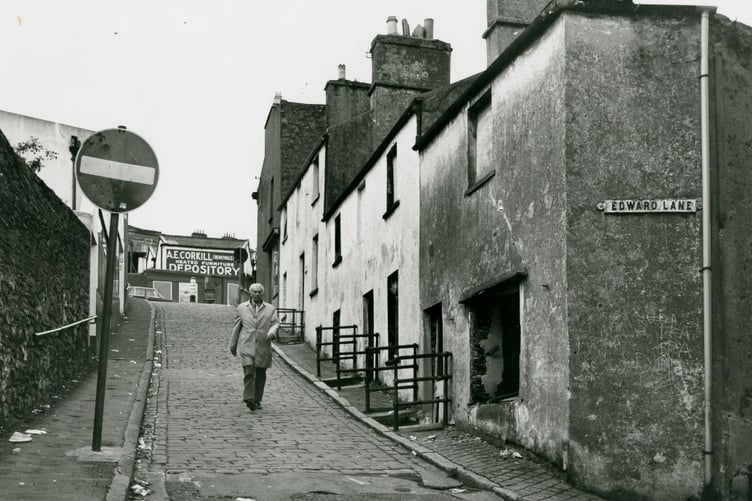 Artist John Nicholson walking down Well Road Hill where he had a studio