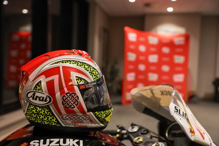 A Suzuki bike and helmet on display