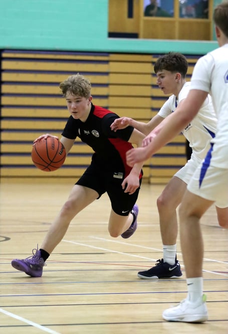Seb Smith drives to the hoop for Ravens past the defence of SOS Cannons' Oliver Hamilton during Thursday evening's league contest at the NSC (Photo: Martin Dunne)