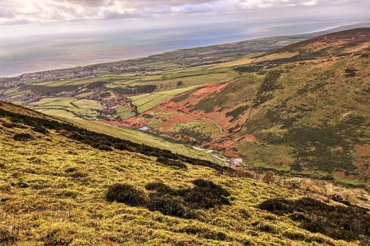 A steep valley leading towards Kirk Michael seen from the top of Slieu Freoaghane