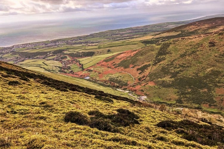 A steep valley leading towards Kirk Michael seen from the top of Slieu Freoaghane