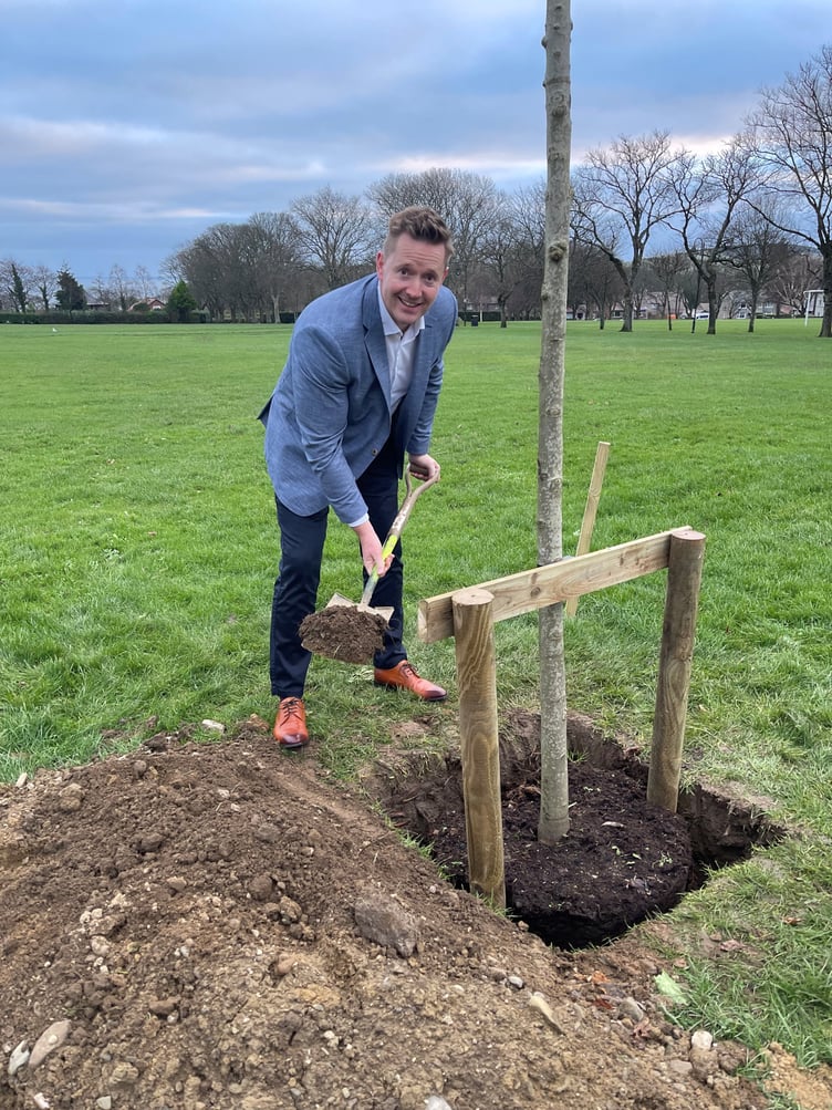 Tom Richards, head of wealth management at Canaccord Genuity, planting the sugar maple tree