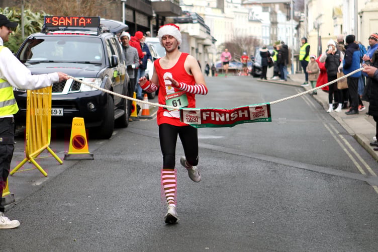 Jordan Cain crosses the finish line on Finch Road to win the Santa Dash for the first time in four minutes and 38 seconds (Photo: Dave Norton)