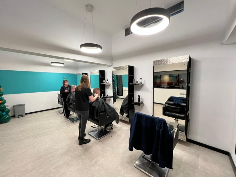 Inside the barber shop which is located on a raised floor at the back of the cafe
