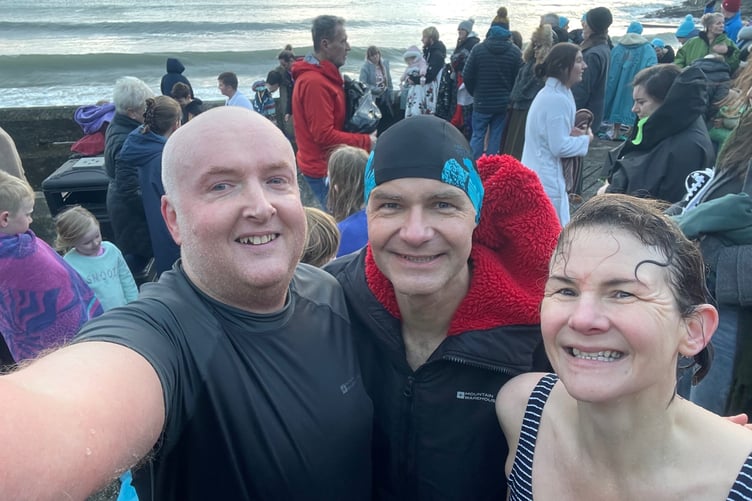 Reporter James Campbell with friends Rob and Katie Crichton after the New Year's Day dip at Chapel Beach, Port St Mary
