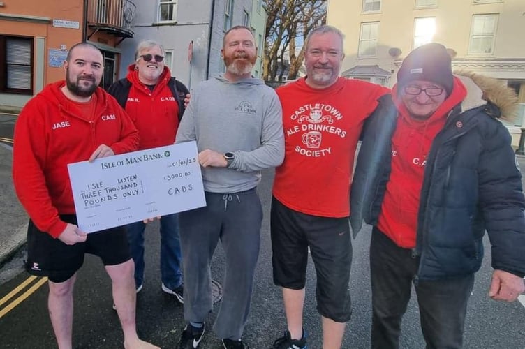 Members of the Castletown Ale Drinkers Society with a cheque of £3,000 for Isle Listen