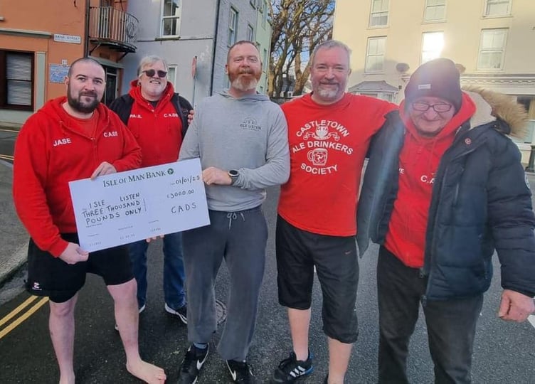 Members of the Castletown Ale Drinkers Society with a cheque of £3,000 for Isle Listen