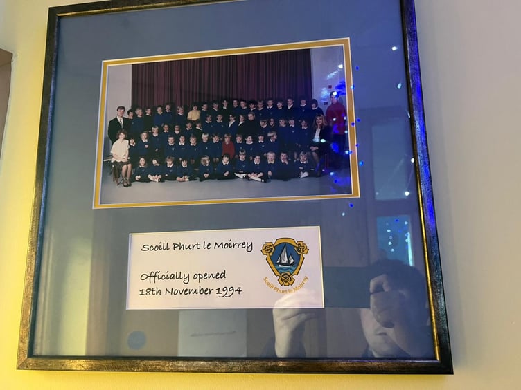 A framed picture of Scoill Phurt Le Moirrey's first school photo in 1994