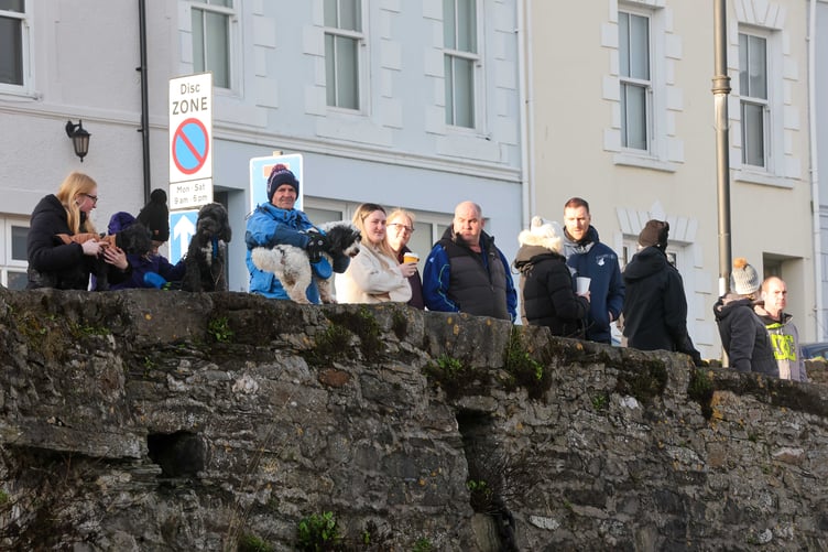 Onlookers watch on at the Inner Harbour