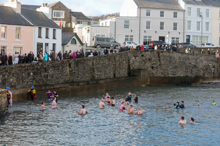 The last of the dippers at the Inner Harbour with spectators watching on