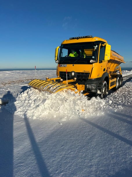 The department has three gritters and a tractor-mounted snow blower operating on the Mountain Road, with plans to move on to Beinn-y-Phott and Tholt-y-Will once conditions allow.