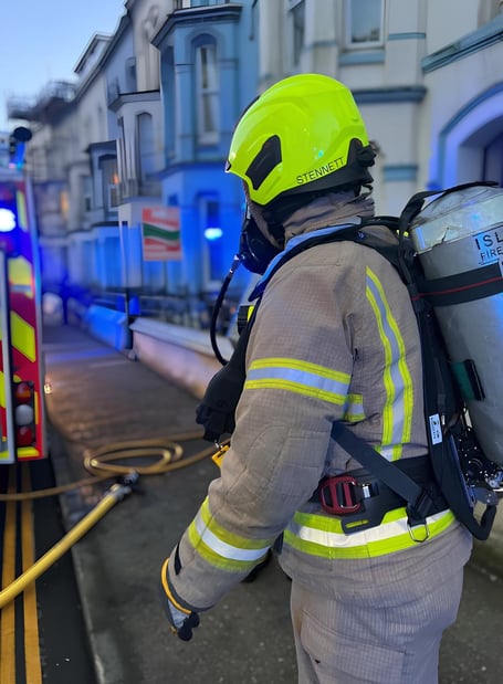A firefighter at the scene of a blaze in Peel Road, Douglas