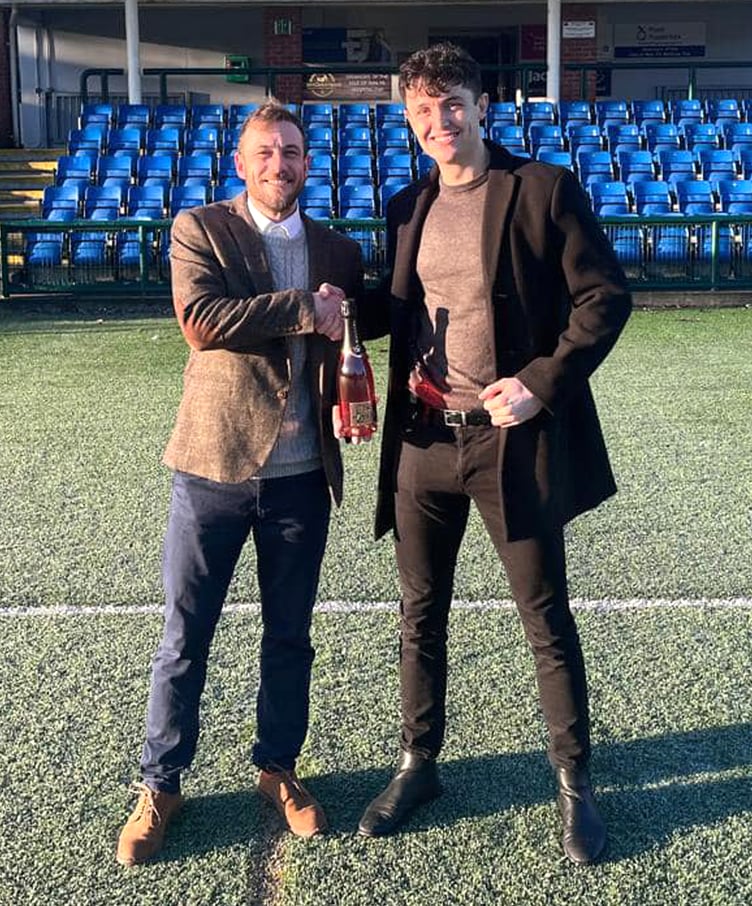 Union Mills striker Jack Murray (right) was named as the player of the round in the preliminary stages of this season's ECAP FA Cup after scoring four goals against Marown recently. He's pictured receiving a bottle of Champagne by Carl Conroy from competition sponsor Exchange Capital Partners