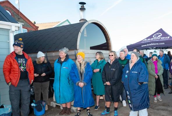 Members of the Northern Dipping Group look on as Lady Lorimer prepares to cut the ribbon