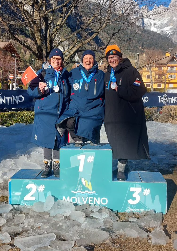 Carole Laporte (left) flies the Manx flag on the podium at the International Ice Swimming Association (IISA) World Championship (Photo: Nigel Hendy)