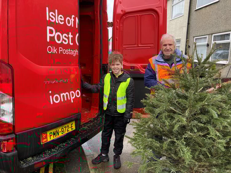 Volunteers with the Isle of Man Post Office help to pick up the Christmas trees