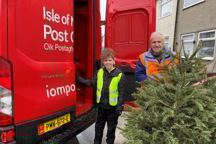 Volunteers with the Isle of Man Post Office help to pick up the Christmas trees