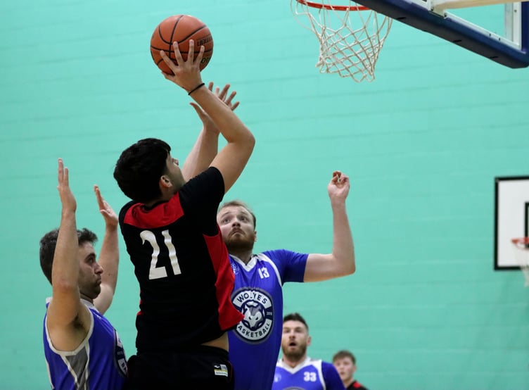 Miltos Provatakis goes to the hoop for Ravens as Wolves' Ross Wilson jumps in for the block during Thursday evening's Senior League match at the NSC (Photo: Oliver Hamilton)