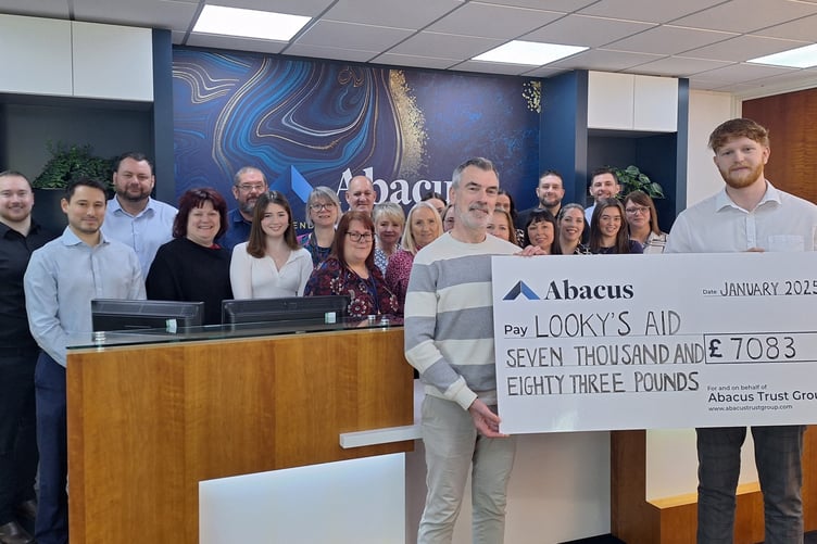 Trust and company administrator Patrick Gough present a cheque to Brett Martin