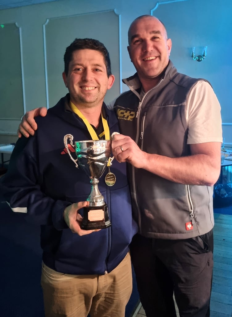 Newly-crowned Patrick Street Chess Congress champion Colin Watkinson (left) receives the winner's trophy from tournament sponsor, Robert Cottier of Island Civils & Plant Ltd