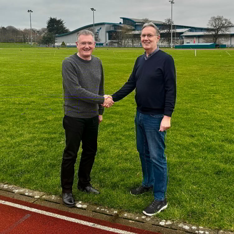 Andy Varnom (on the right) handing over to Gary Weightman as general secretary of the International Island Games Association (IIGA)