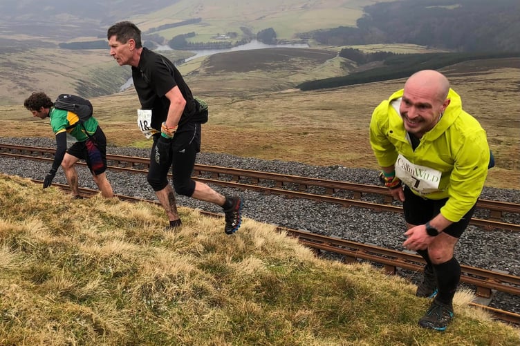Having negotiated the tram tracks, (left to right) Phil Ellis, Alan Sandford and Nick Bowden tackle one of the steep climbs during the weekend's fell race (Photo: Steve Partington)