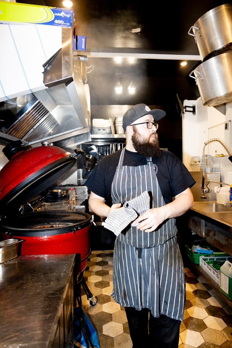 Sam Levi, co-owner of Smoky Sam's Smokehouse, hard at work inside the venue's kitchen
