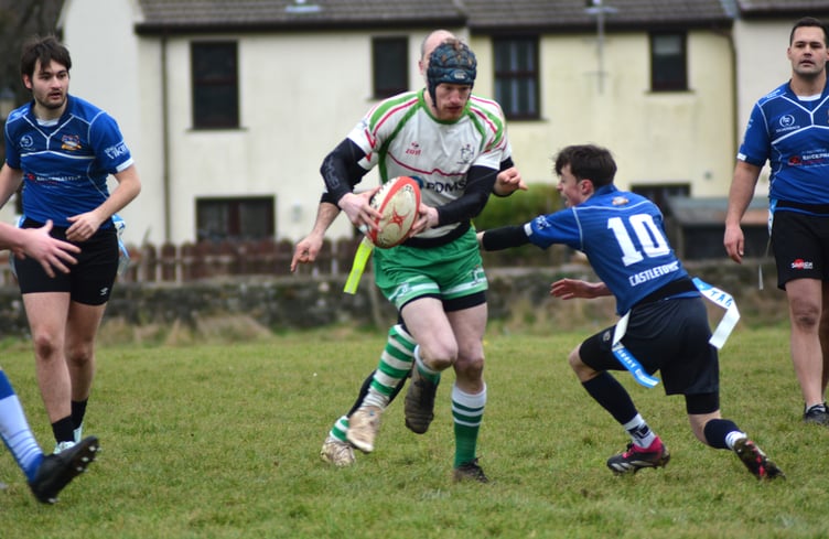 Southern Nomads' Harry Brereton looks to evade the challenge of Castletown's Hugo Hughes during last week's tag rugby match at Ballakilley in Port Erin. Nomads take on Douglas Casuals at the same venue this Saturday afternoon, kicking off at 2.15pm (Photo: Andy Dalrymple)