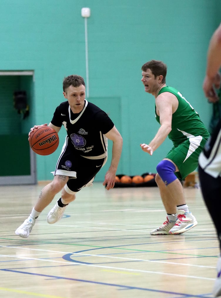 Jets' Tom Dalton-Brown drives through the gap in Cavaliers' zone defence on his way to the hoop during Thursday's league match at the NSC (Photo: Martin Dunne)