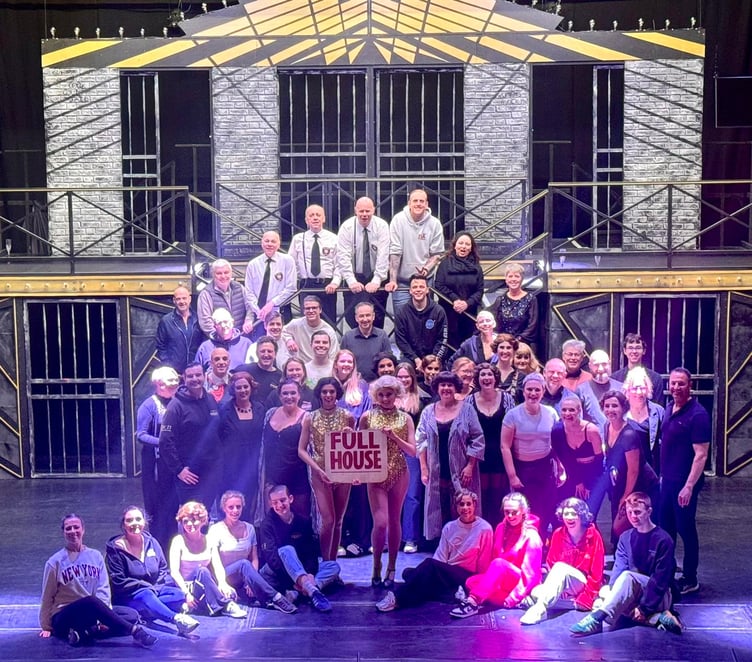 The Chicago cast with 'full house' sign