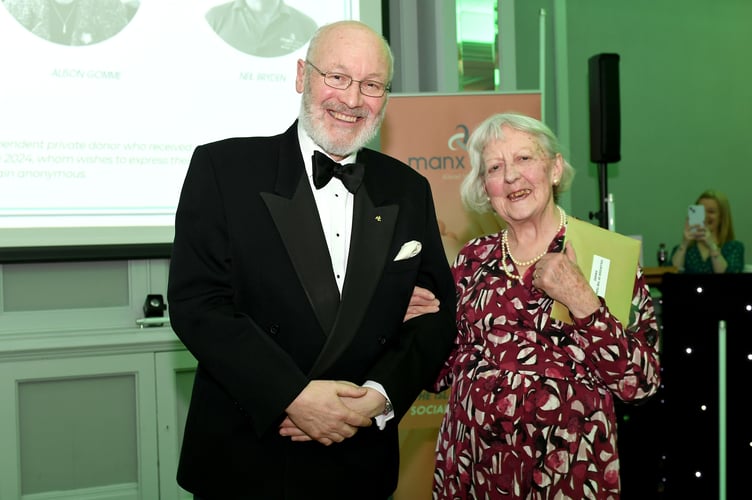 Lieutenant Governor Sir John Lorimer presents the Volunteer of the Year award to Susanne Gallagher