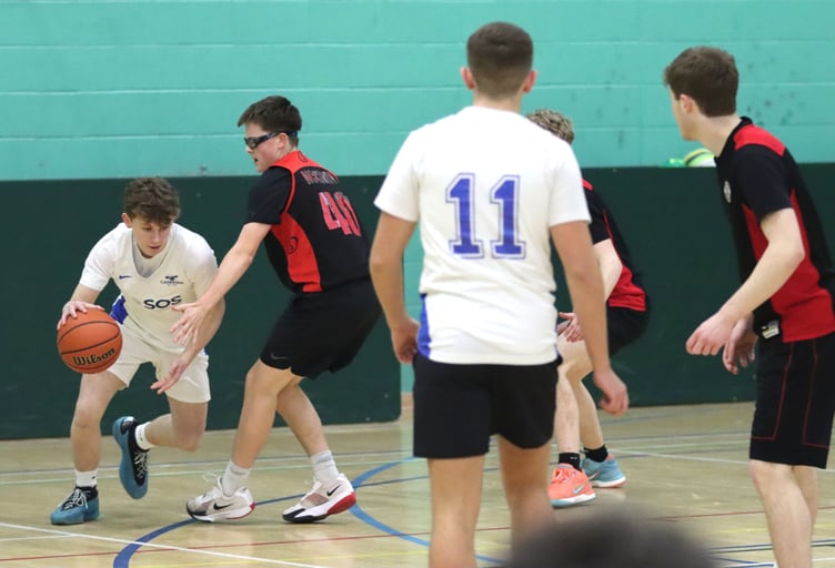 Cannons' Rowan Coulter (left) drives under pressure from the defence of Ravens' Zac Hand. Ravens won a narrow 54-51 in their third match up against Cannons