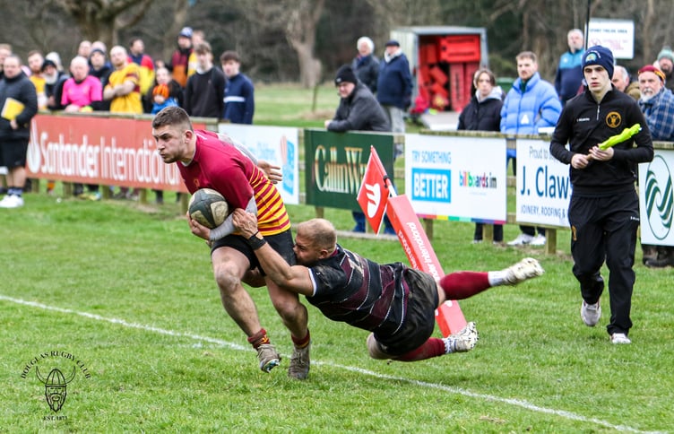 Cal Dentith attempts to shrug off the close attentions of a Bowdon opponent during Saturday's Regional Two North West clash at Port-e-Chee (Photo: Richard Ebbutt)