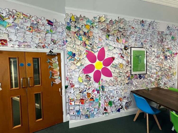 The mural is spread across the room on each wall