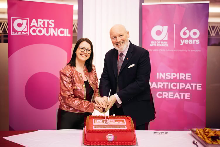 Sarah Maltby MHK and John Lorimer cutting the cake