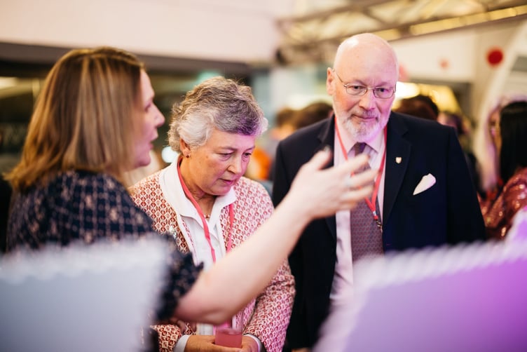 Lady Lorimer and Sir John Lorimer being shown the special stamps