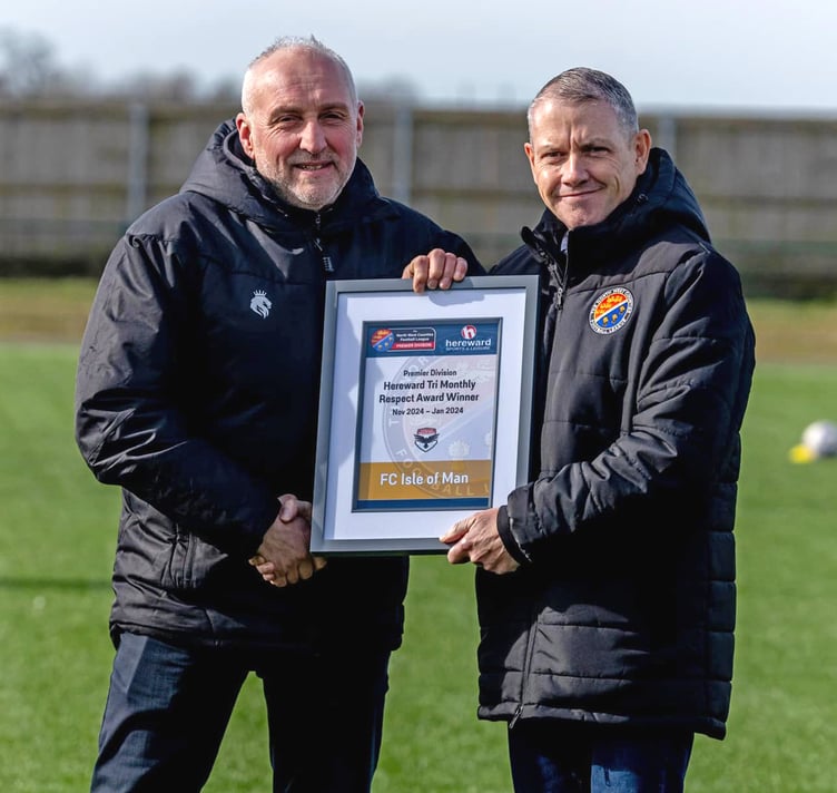FC Isle of Man club director Andy Birchall (left) receives the Premier Division Respect award from league chairman Paul Lawler during the Ravens’ away fixture against Burscough (Photo: Hannah McHugh)