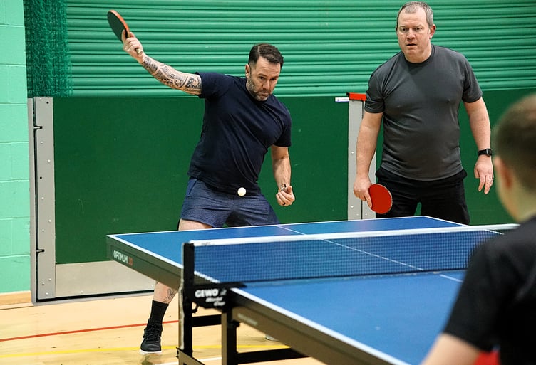 Brandon Montgomery, playing alongside Desmond's team-mate Neil Ronan, unleashes a winning backhand in the doubles last week (Photo: Malcolm Lambert).