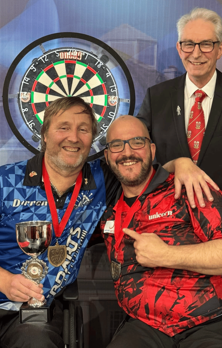 (Left to right) Isle of Man disability darter Darren Kennish with world champion Vincent D'Hondt and Ian Tilley of England Darts after winning two trophies at the recent Isle of Man Dartshopper Darts Festival