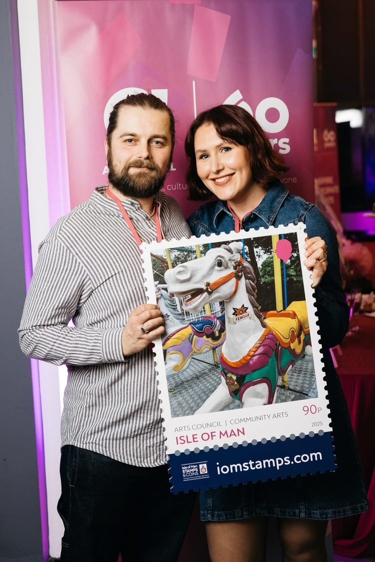 Charles and Ealish Hunt with the Arts Council anniversary stamp which features their work at Silverdale