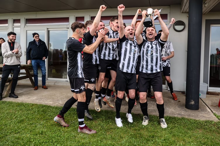 Colby Combi captain Seb Spiers lifts the Ardern and Druggan Combination Two title at Station Fields