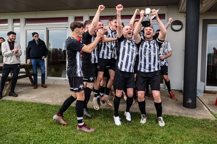 Colby Combi captain Seb Spiers lifts the Ardern and Druggan Combination Two title at Station Fields