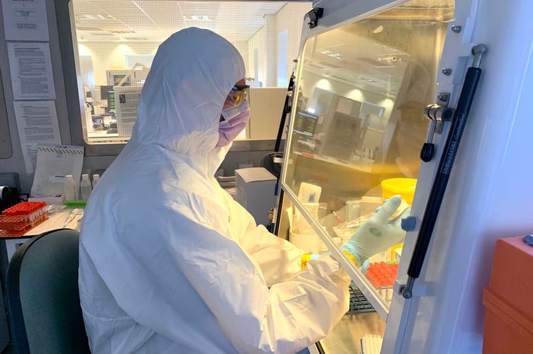 Chris Helm (Senior Biomedical Scientist) processing swabs in the containment suite at Noble's Hospital pathology lab