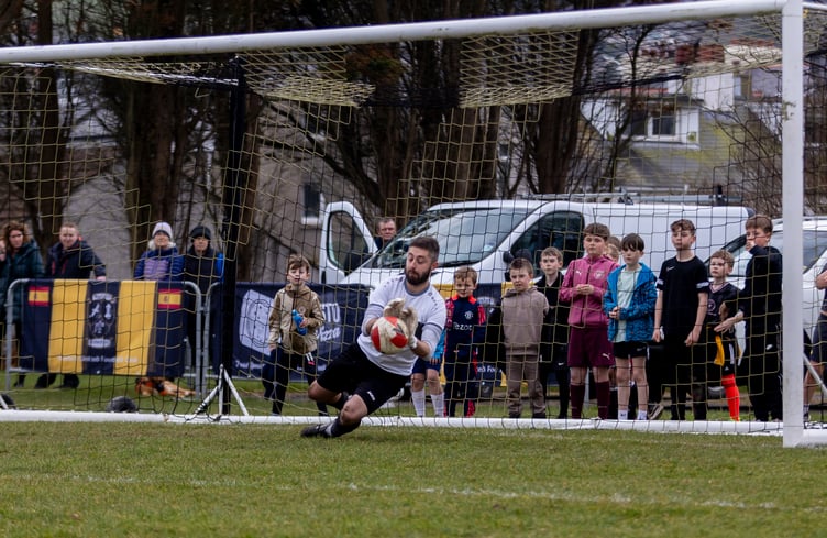 Foxdale goalkeeper Andy Ball produces one of his three penalty saves during the shootout at the end of a dramatic ECAP FA Cup clash with Rushen United at Croit Lowey last weekend (Photo: Gary Weightman)